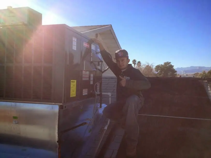 HVAC technician performing HVAC Inspection on a rooftop unit in San Luis Obispo